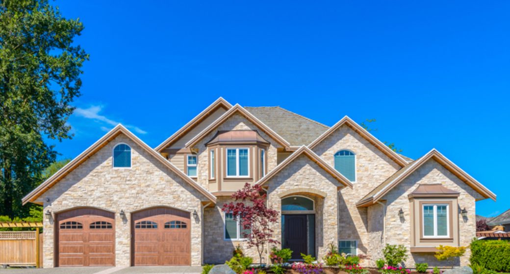 Stone-front two-story home with an attached two-car garage